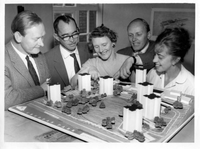 T Dan Smith Archive: T Dan Smith and 4 others examining model of Cruddas Park flats, c. 1960