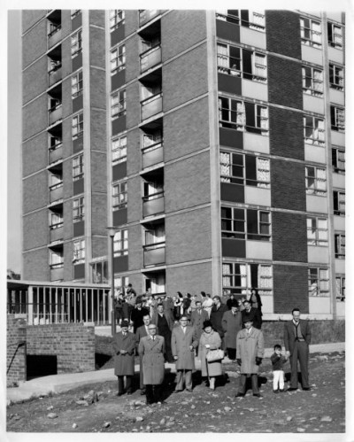 T Dan Smith Archive: Group of people outside of Scotswood Road flats, c. 1960s