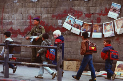 Gaza Strip: Gaza town schoolchildren pass Israeli soldiers, 1987/1988