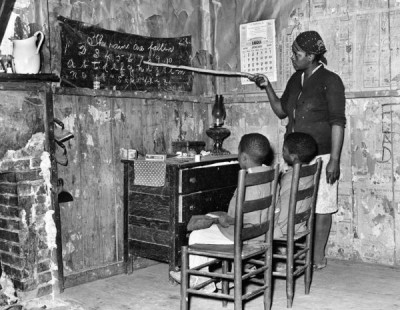 Russell Lee Collection: Mother teaching children numbers and alphabet in home of sharecropper, Transylvania, Louisiana, 1939