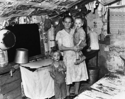 Russell Lee Collection: Mrs. John Whitehead, Wife of Miner, and Two of Her Children (or grandchildren) In the Kitchen of Her Three Room House, 31st August 1946