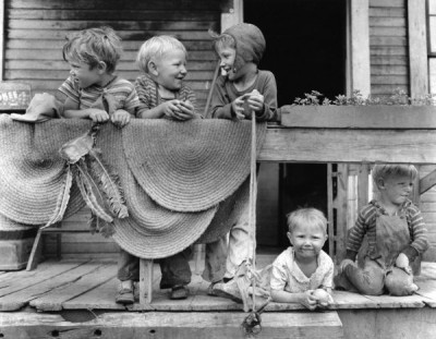 Russell Lee Collection: Children of miners on front porch of house in company project. Osage, Monongalia County, West Virginia, 14th June 1946