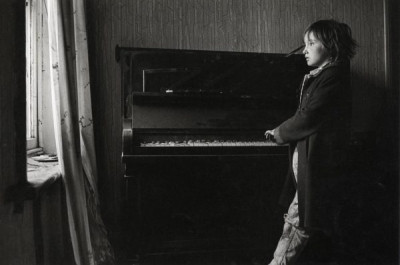 Byker: Heather Playing the Piano in a Derelict House, 1971