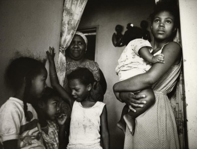 Bitter Harvest: Interior, with families, of farm cottage provided for the extended families of ‘Coloured’ farm workers, 1989